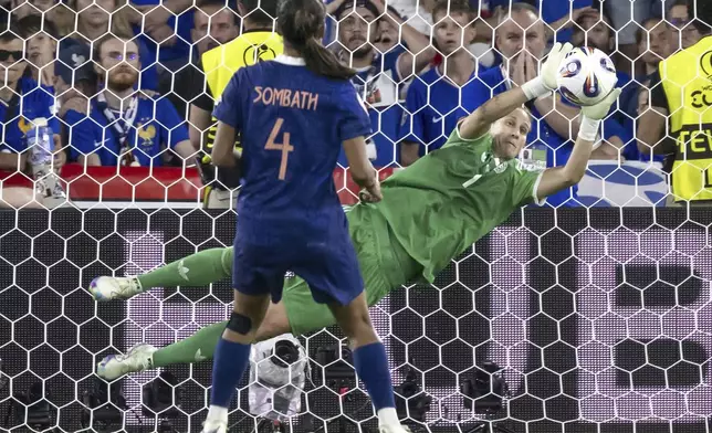 Germany's goalkeeper Ann-Katrin Berger, right, saves the decisive penalty of France's Alice Sombath in the Women's Euro 2025 quarterfinals soccer match between France and Germany at St. Jakob-Park in Basel, Switzerland, Saturday, July 19, 2025. (Georgios Kefalas/Keystone via AP)