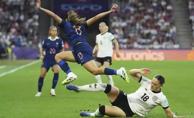 Germany's Giovanna Hoffmann, right, challenges France's Selma Bacha during the Women's Euro 2025 quarterfinals soccer match between France and Germany at St. Jakob-Park in Basel, Switzerland, Saturday, July 19, 2025. (AP Photo/Martin Meissner)