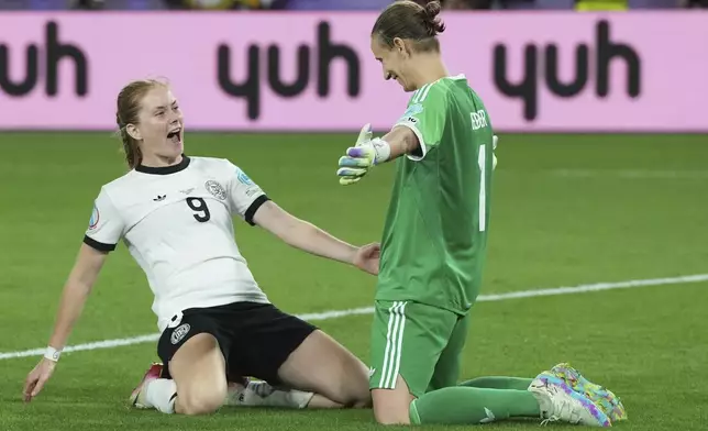 Germany goalkeeper Ann-Katrin Berger, right, and Germany's Sjoeke Nuesken celebrate after winning the Women's Euro 2025 quarterfinals soccer match between France and Germany at St. Jakob-Park in Basel, Switzerland, Saturday, July 19, 2025. (AP Photo/Martin Meissner)