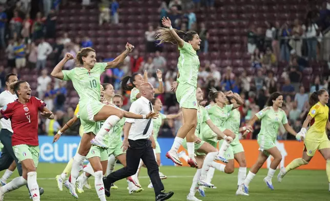 Italy's Cristiana Girelli, center left, and Sofia Cantore center right, jump celebrating at the end of the Women's Euro 2025 quarterfinals soccer match between Norway and Italy at Stade de Geneve in Geneva, Switzerland, Wednesday, July 16, 2025. (AP Photo/Alessandra Tarantino)