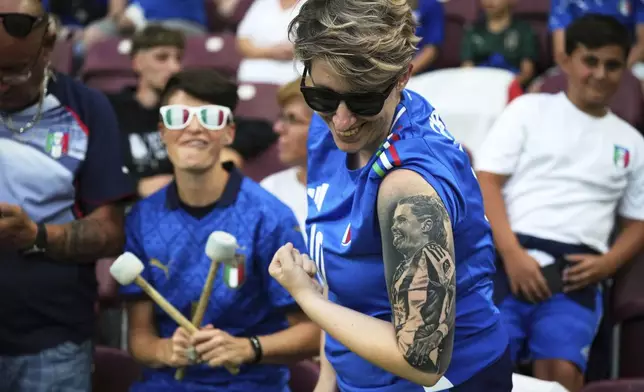 Italy supporter Elena shows off a tattoo of Italian team captain Cristiana Girelli on the stands before the Women's Euro 2025 quarterfinals soccer match between Norway and Italy at Stade de Geneve in Geneva, Switzerland, Wednesday, July 16, 2025. (AP Photo/Alessandra Tarantino)