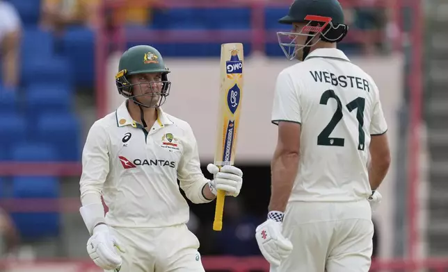 Australia's Alex Carey celebrates with partner Beau Webster scoring a half-century against West Indies during day one of the second cricket Test match at National Cricket Stadium in St. George's, Grenada, Thursday, July 3, 2025. (AP Photo/Ricardo Mazalan)