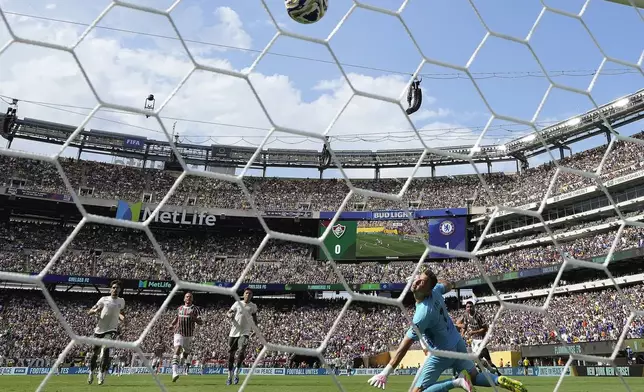 Fluminense goalkeeper Fabio watches as the ball sails into the net for a goal by Chelsea's Joao Pedro during the second half of a Club World Cup semifinal soccer match in East Rutherford, N.J., Tuesday, July 8, 2025. (AP Photo/Frank Franklin II)