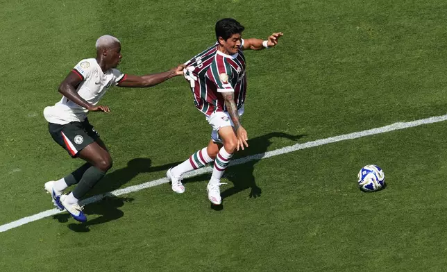 Chelsea's Moises Caicedo, left, grabs Fluminense's German Cano during the Club World Cup semifinal soccer match between Fluminense and Chelsea in East Rutherford, N.J., Tuesday, July 8, 2025. (AP Photo/Pamela Smith)