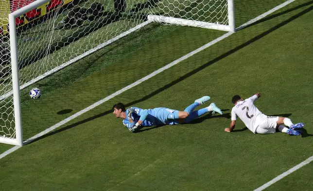 Real Madrid's Thibaut Courtois (1) and Dani Carvajal (2) look on at a goal scored by Paris Saint-Germain's Goncalo Ramos (9) during the Club World Cup semifinal soccer match between PSG and Real Madrid in East Rutherford, N.J., Wednesday, July 9, 2025. (AP Photo/Pamela Smith)