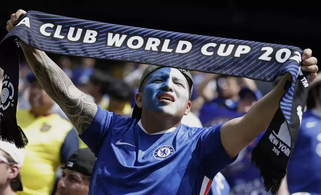A Chelsea fan lifts a scarf prior to the Club World Cup semifinal soccer match between Fluminense and Chelsea in East Rutherford, N.J., Tuesday, July 8, 2025. (AP Photo/Adam Hunger)