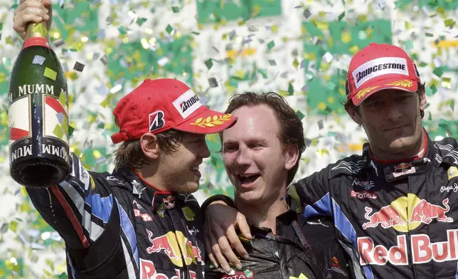 FILE -First place Red Bull driver Sebastian Vettel, of Germany, left, Red Bull team principal Christian Horner, center, and second place Red Bull driver Mark Webber, of Australia, celebrate on the podium after winning Brazil's Formula One Grand Prix at the Interlagos race track in Sao Paulo, Brazil, Nov. 7, 2010. (AP Photo/Luca Bruno), File)