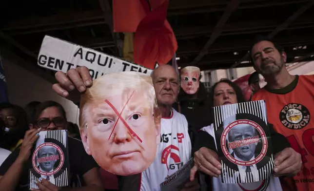 Demonstrators protest U.S. President Donald Trump's announcement of 50% tariffs on Brazilian goods and against U.S. report that cited counterfeit product sales in Brazil, in Sao Paulo, Friday, July 18, 2025. (AP Photo/Ettore Chiereguini)