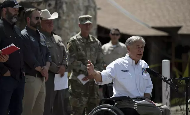 Texas Gov. Greg Abbott speaks during a press conference on Tuesday, July 8, 2025, after touring damage from flash flooding in Hunt, Texas. (AP Photo/Eli Hartman)