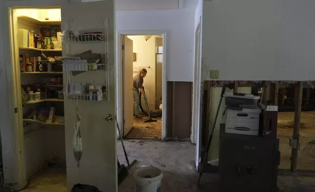 Volunteer Cameron Carpenter helps clean up a house after flooding in Kerrville, Texas on Tuesday, July 8, 2025. (AP Photo/Ashley Landis)