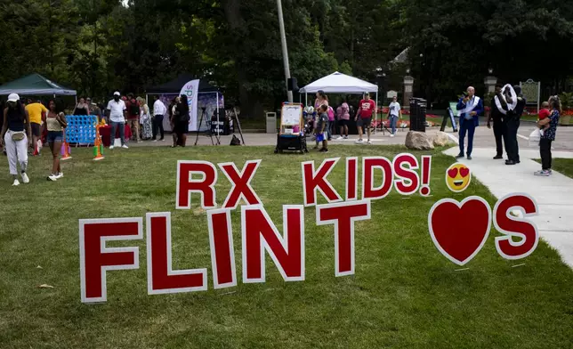 Families and community members arrive for the Flint Rx Kids Baby Parade event on July 25, 2025 on the Applewood Campus in Flint, Michigan. The event celebrates the continued impact of Rx Kids on Flint families and babies. (AP Photo/Emily Elconin)