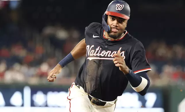 Washington Nationals' James Wood scores during the eighth inning of a baseball game against the Detroit Tigers, Thursday, July 3, 2025, in Washington. (AP Photo/Daniel Kucin Jr.)