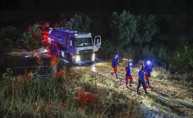Firefighters work to extinguish a wildfire in Bursa, Turkey, early on Sunday, July 27, 2025. (Sercan Ozkurnazli/DIA Images via AP)