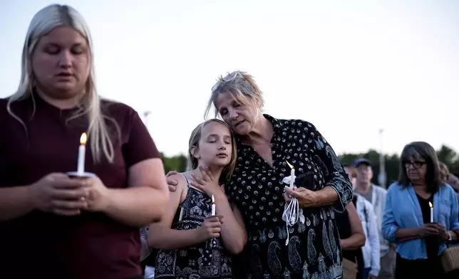 People gather at a vigil for a nine-year-old Montreal girl whose body was found in their community over the weekend, in Ticonderoga, in Essex County, N.Y., Tuesday, July 22, 2025. (Christopher Katsarov/The Canadian Press via AP)