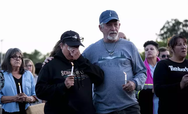 People gather at a vigil for a nine-year-old Montreal girl whose body was found in their community over the weekend, in Ticonderoga, in Essex County, N.Y., Tuesday, July 22, 2025. (Christopher Katsarov/The Canadian Press via AP)
