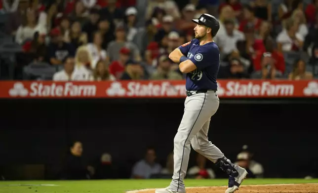Seattle Mariners' Cal Raleigh gestures after hitting a home run during the sixth inning of a baseball game against the Los Angeles Angels, Saturday, July 26, 2025, in Anaheim, Calif. (AP Photo/William Liang)