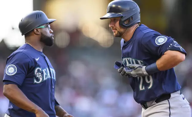 Seattle Mariners Cal Raleigh gestures after hitting a single during the first inning of a baseball game against the Los Angeles Angels Saturday, July 26, 2025, in Anaheim, Calif. (AP Photo/William Liang)