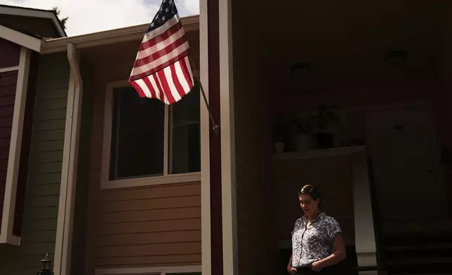 Havalah Hopkins, a single mother who lives in government-subsidized housing with her teenage son, poses for a portrait outside her apartment Thursday, July 10, 2025, in Woodinville, Wash. (AP Photo/Lindsey Wasson)