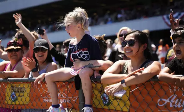 Spectators react during the "T-Rex World Championship Races" at Emerald Downs, Sunday, June 29, 2025, in Auburn, Wash. (AP Photo/Lindsey Wasson)