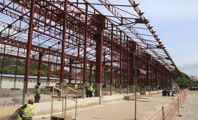 FILE - Construction workers make progress in Belem, Brazil, Sept. 24, 2024, on a project for the COP30 U.N. Climate Summit. (AP Photo/Paulo Santos, File)