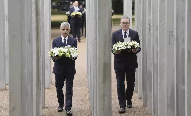 Mayor of London Sadiq Khan, left, and Britain's Prime Minister Keir Starmer lay a wreath at the 7/7 Memorial, in Hyde Park to mark the anniversary of the terrorist attacks in London July 7, 2005 that killed 52 people, in London, Monday July 7, 2025. (Stefan Rousseau/PA via AP)