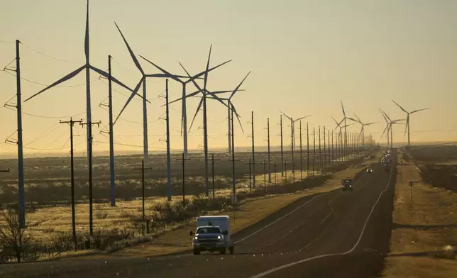 FILE - Wind turbines are visible along Route 176 as vehicles travel eastbound Feb. 24, 2025, in Andrews, Texas. (AP Photo/Julio Cortez, File)