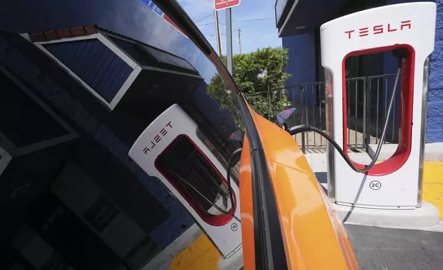 FILE - An electric vehicle charges at a station May 22, 2025, in Long Beach, Calif. (AP Photo/Damian Dovarganes, File)