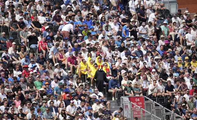 Fans watch the third day of the fourth cricket test match between England and India at Emirates Old Trafford, Manchester, England, Friday, July 25, 2025. (AP Photo/Jon Super)