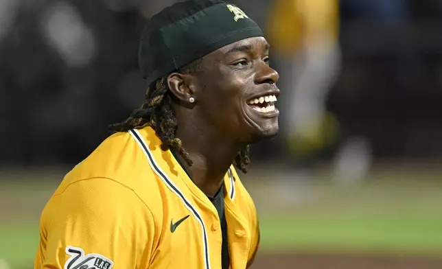 Athletics' Lawrence Butler celebrates after his two-RBI triple during the ninth inning of a baseball game against the Tampa Bay Rays, Monday, June 30, 2025, in Tampa, Fla. (AP Photo/Jason Behnken)