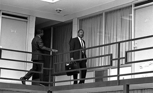 FILE - Rev. Martin Luther King, Jr. walks across the balcony of the Lorraine Motel in Memphis, April 3, 1968. (AP Photo/Charles Kelly, File)