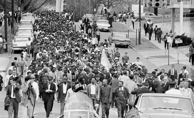 FILE - Demonstrators walk to the courthouse behind the Rev. Martin Luther King Jr. in Montgomery, Ala., March 17, 1965, to protest treatment of demonstrators by police during an attempted march. (AP Photo/File)