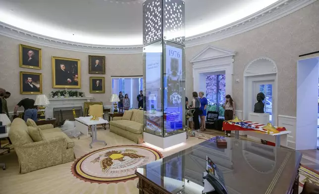 People work during an effort to transition a replica of the White House Oval Office from the days of former President Joe Biden with President Donald Trump's decor, at the White House Historical Association in Washington, Wednesday, July 23, 2025. (AP Photo/Rod Lamkey, Jr.)