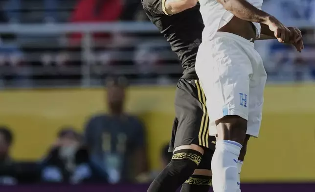 Mexico defender Johan Vásquez, left, and Honduras forward Choco Lozano jump for the ball during the first half of a CONCACAF Gold Cup semifinal soccer match Wednesday, July 2, 2025, in Santa Clara, Calif. (AP Photo/Godofredo A. Vásquez)