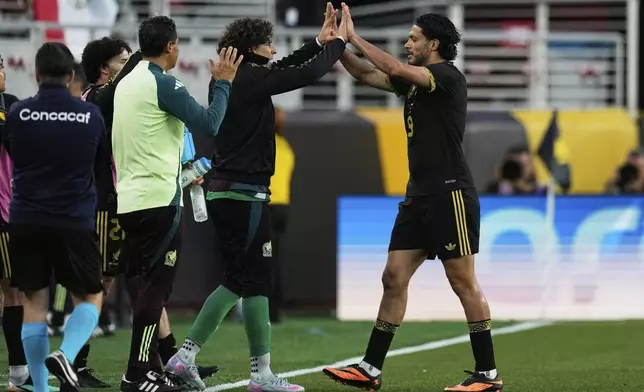 Mexico forward Raúl Jiménez, right, celebrates with teammate Guillermo Ochoa after scoring a goal during the second half of a CONCACAF Gold Cup semifinal soccer match against Honduras, Wednesday, July 2, 2025, in Santa Clara, Calif. (AP Photo/Godofredo A. Vásquez)