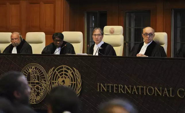 Presiding judge Yuji Iwasawa, second from right, speaks at a hearing to deliver an advisory opinion on what legal obligations nations have to address climate change and what consequences they may face if they don't, Wednesday, July 23, 2025, in The Hague, Netherlands. (AP Photo/Peter Dejong)