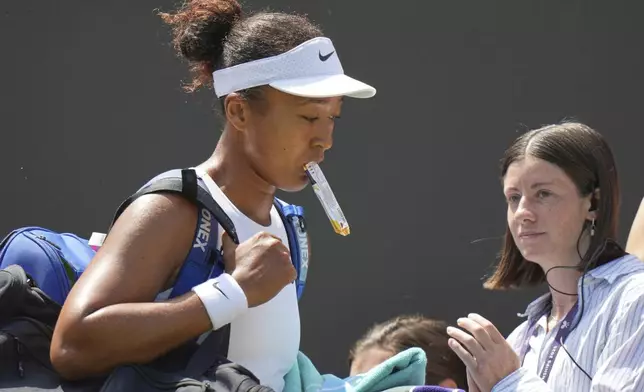 Naomi Osaka of Japan leaves the court after losing to Russia's Anastasia Pavlyuchenkova during a third round women's singles match at the Wimbledon Tennis Championships in London, Friday, July 4, 2025. (AP Photo/Alastair Grant)