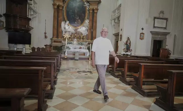 Father Tadeusz Rozmu walks in the San Tommaso da Villanova church of the town of Castel Gandolfo, a historic summer retreat for popes about 30 kilometers southeast of Rome, where Pope Leo XIV will be spending a short period of rest, is seen Wednesday, July 2, 2025. (AP Photo/Andrew Medichini)