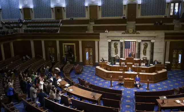 House Minority Leader Hakeem Jeffries, D-N.Y., left, speaks in the House chamber as House Democrats stand to applaud him, prior to the final vote for President Donald Trump's signature bill of tax breaks and spending cuts, at the Capitol, Thursday, July 3, 2025, in Washington. (AP Photo/Rod Lamkey, Jr.)
