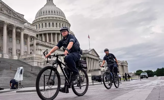 U.S. Capitol Police patrol the plaza as House Republicans work inside to pass President Donald Trump's signature bill of tax breaks and spending cuts by a self-imposed Fourth of July deadline, at the Capitol in Washington, Wednesday, July 2, 2025. (AP Photo/J. Scott Applewhite)