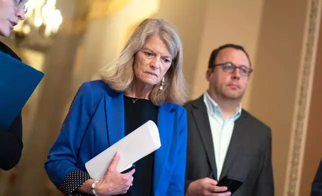 Sen. Lisa Murkowski, R-Alaska, left, a member of the Senate Appropriations Committee, arrives for a closed-door Republican meeting to advance President Donald Trump's sweeping domestic policy bill, at the Capitol in Washington, Friday, June 27, 2025. (AP Photo/J. Scott Applewhite)