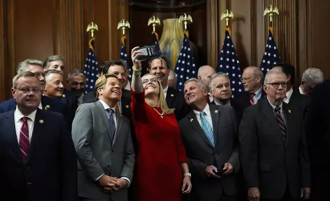 Republican members of Congress take a selfie following the passage of President Donald Trump's signature bill of tax breaks and spending cuts, Thursday, July 3, 2025, at the Capitol in Washington. (AP Photo/Julia Demaree Nikhinson)