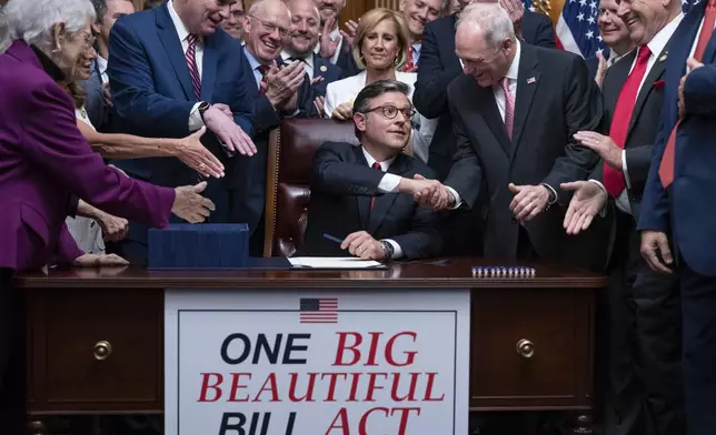 Speaker of the House Mike Johnson, R-La., center, shakes hands with Majority Leader Steve Scalise, R-La., as he celebrates with fellow Republicans after final passage of President Donald Trump's signature bill of tax breaks and spending cuts, at the Capitol in Washington, Thursday, July 3, 2025. (AP Photo/J. Scott Applewhite)