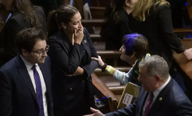 Rep. Alexandria Ocasio-Cortez, D-N.Y., center left, talks with Rep. Rosa DeLauro, D-Conn., in the House chamber during final passage of President Donald Trump's signature bill of tax breaks and spending cuts, at the Capitol, Thursday, July 3, 2025, in Washington. (AP Photo/Rod Lamkey, Jr.)