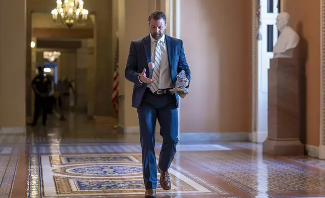 Sen. Markwayne Mullin, R-Okla., bounces a ball off the marble floor near the Senate chamber as Republicans make their final push to advance President Donald Trump's tax breaks and spending cuts package, at the Capitol in Washington, Monday, June 30, 2025. (AP Photo/J. Scott Applewhite)