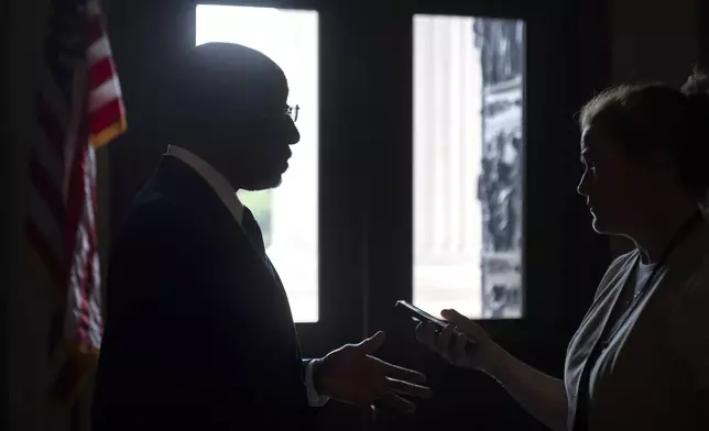 Sen. Raphael Warnock, D-Ga., speaks to reporters as Republicans begin a final push to advance President Donald Trump's tax breaks and spending cuts package, at the Capitol in Washington, Monday, June 30, 2025. (AP Photo/Mark Schiefelbein)