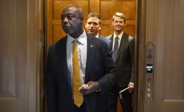 Sen. Tim Scott, R-S.C., steps out of an elevator as Republicans begin a final push to advance President Donald Trump's tax breaks and spending cuts package, at the Capitol in Washington, Monday, June 30, 2025. (AP Photo/Mark Schiefelbein)