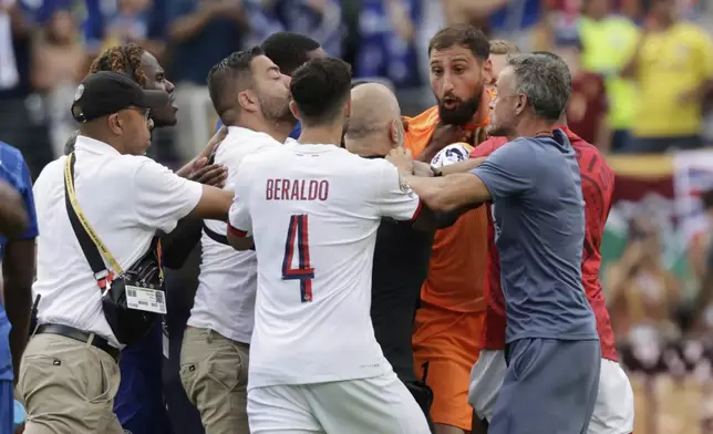 Paris Saint-Germain and Chelsea players scuffle after the Club World Cup final soccer match in East Rutherford, N.J., Sunday, July 13, 2025. (AP Photo/Adam Hunger)