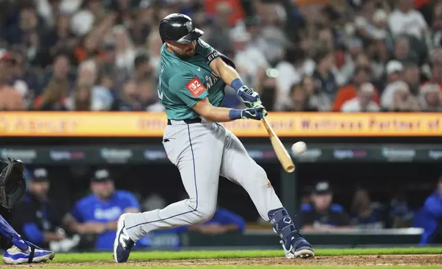 Seattle Mariners' Cal Raleigh hits a grand slam against the Detroit Tigers in the ninth inning during a baseball game, Friday, July 11, 2025, in Detroit. (AP Photo/Paul Sancya)