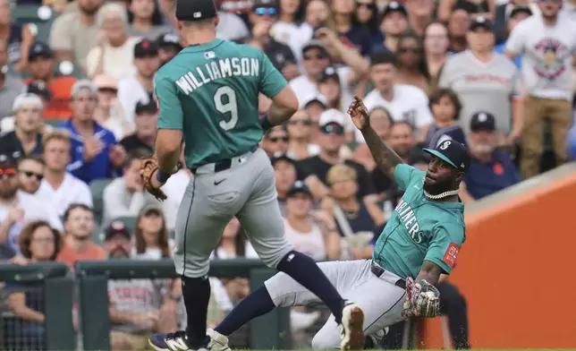 Seattle Mariners left fielder Randy Arozarena catches a Detroit Tigers' Colt Keith fly ball as Ben Williamson (9) looks on in the third inning during a baseball game, Friday, July 11, 2025, in Detroit. (AP Photo/Paul Sancya)