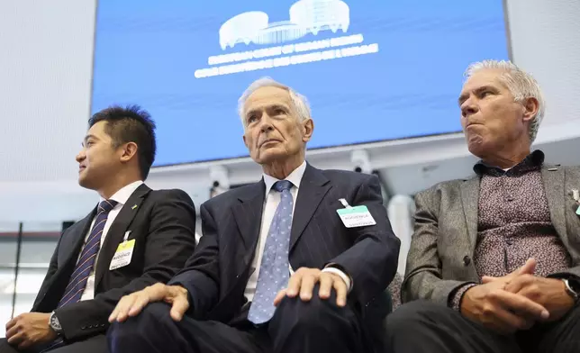 Netherland's Anton Kotte, center, who lost his son and other family members in the the downing of Malaysia Airlines flight MH17, sits in the European Court of Human Rights before it issues a landmark set of rulings about alleged Russian violations in Ukraine since 2014, including the downing of Malaysia Airlines flight MH17, Wednesday, July 9, 2025 in Strasbourg, eastern France. (AP Photo/Antonin Utz)